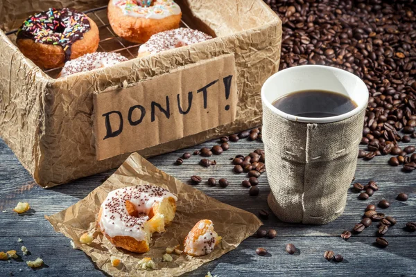 Box full of donuts with coffee — Stock Photo, Image