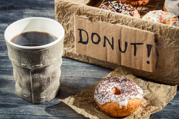 Hot coffee and box with donuts — Stock Photo, Image