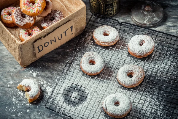 Tasting freshly baked donuts — Stock Photo, Image