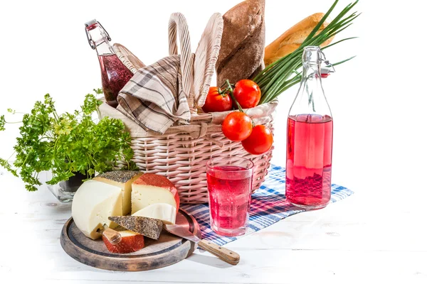 Picnic basket with vegetables and cheese — Stock Photo, Image