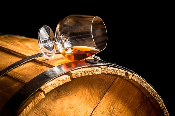 Glass of cognac on the vintage barrel — Stock Photo, Image