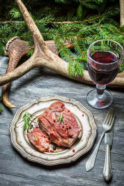 Closeup of roasted venison with red wine — Stock Photo, Image