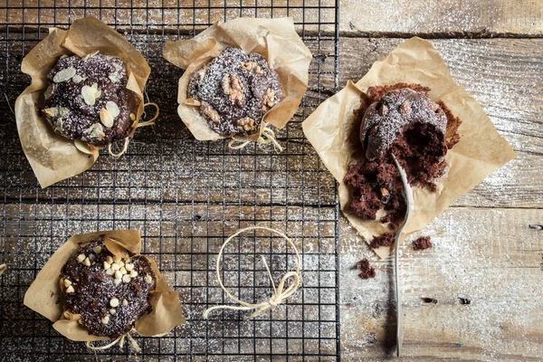 Closeup of tasting freshly baked chocolate muffins — Stock Photo, Image