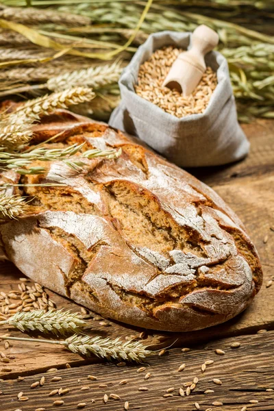 Healthy bread and a bag with grains — Stock Photo, Image