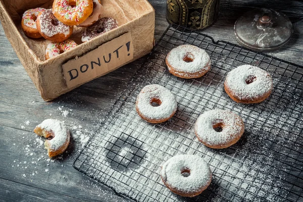 Tasting sweet donuts with icing sugar — Stock Photo, Image