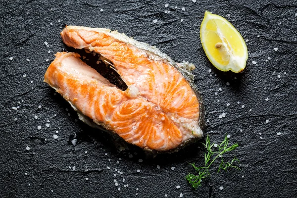 Freshly fried salmon served on a rock — Stock Photo, Image