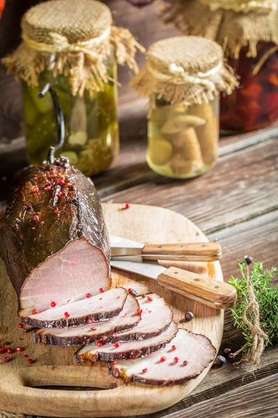 Tasting fresh piece of ham in a smokehouse — Stock Photo, Image