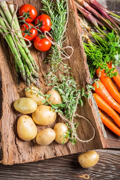 Various fresh vegetables on bark — Stock Photo, Image