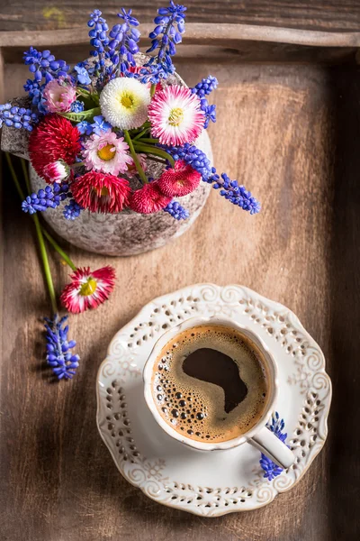Coffee and spring flowers on old wooden tray — Stock Photo, Image