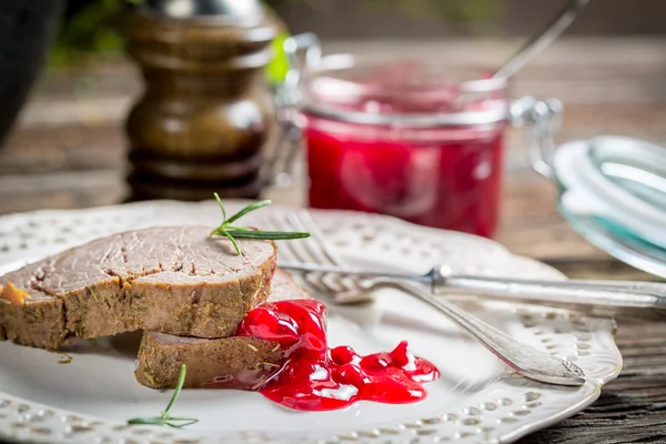 Venison with cranberry sauce on white plate — Stock Photo, Image