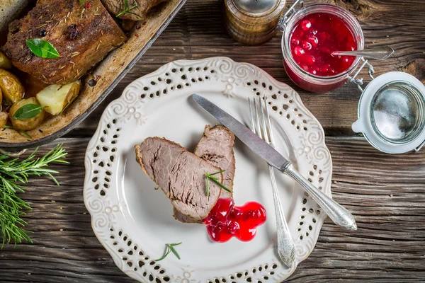 Venado con salsa de arándanos en plato blanco —  Fotos de Stock