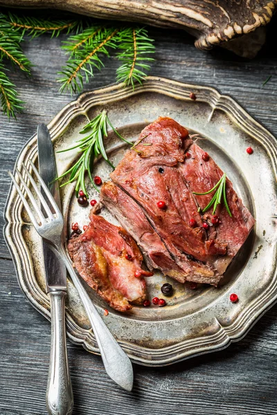 Venison served with rosemary and pepper — Stock Photo, Image