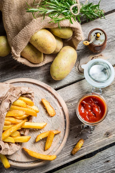 Batatas fritas caseiras com ketchup e sal — Fotografia de Stock