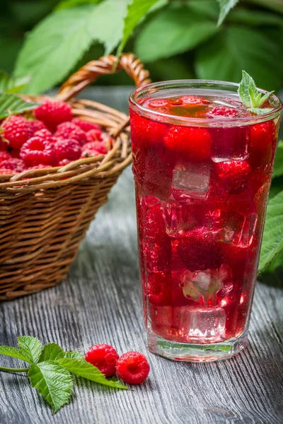 Juice of fresh raspberries served with ice in a glass — Stock Photo, Image