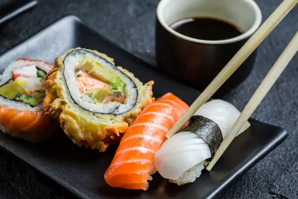 Closeup of sushi served in the dark ceramics — Stock Photo, Image