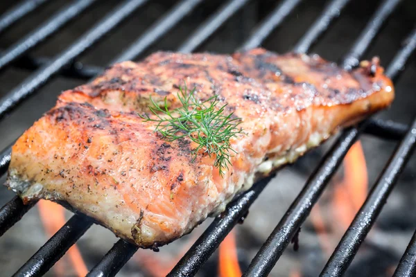 Baked salmon on the grill with fire — Stock Photo, Image