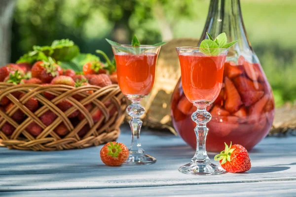 Homemade strawberry liqueur served in the garden — Stock Photo, Image