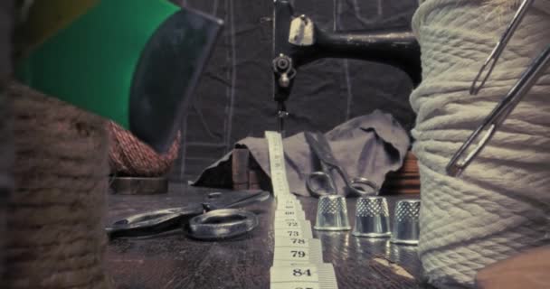 Antique tailor's workshop with spools thread, scissors and sewing machine. — Stock Video