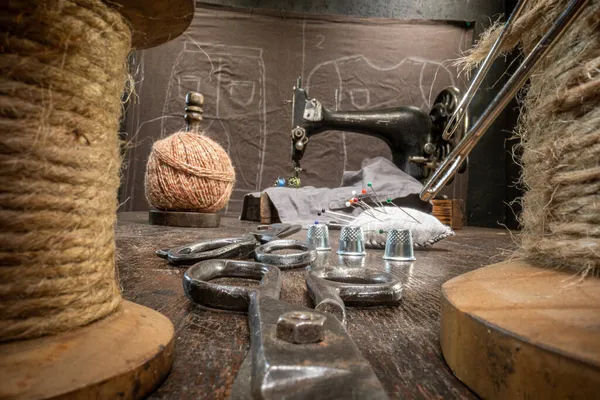 Traditional tailor workshop with scissors and sewing machine. Vintage weaving workshop.