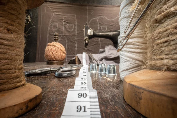 Traditional tailor workshop with tape measure and threads on spools. Vintage weaving workshop.