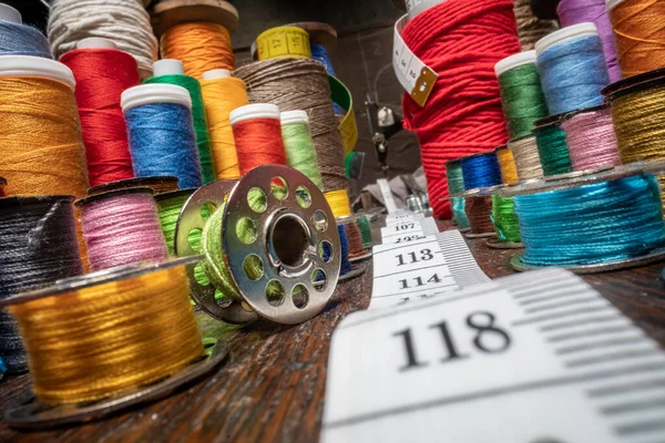 Traditional tailor workshop full of colorful thread on spools. Vintage weaving workshop.