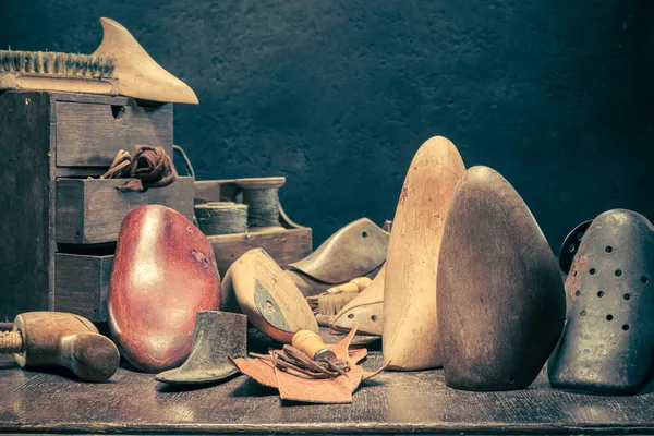 Traditional shoemaker workshop with with tools, anvil, shoes and rule. Traditional shoemaker workshop