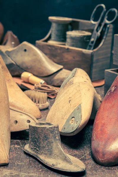 Antique shoemaker workshop with with tools, anvil, shoes and rule. Antique shoemaker workshop