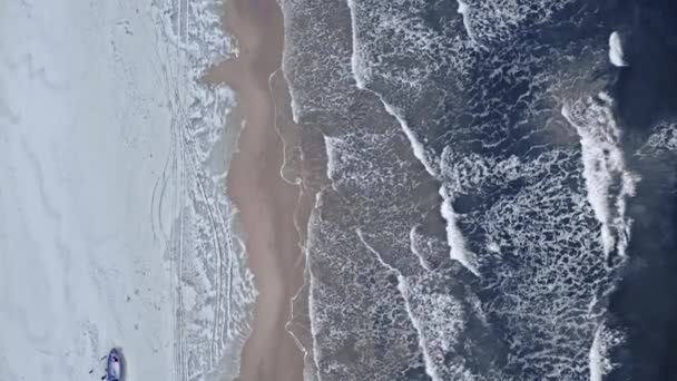 Fishing boat on snowy beach and winter swimmer, Baltic Sea — Wideo stockowe