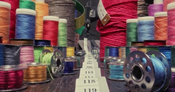 Small tailor workshop full of colorful thread on spools. — Stock Video