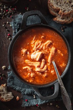 Tasty and hot tripe soup made of pork and spices. Spicy and aromatic tripe soup seasoned with pepper and served with bread.