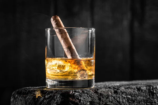 Cigare Dans Verre Whisky Avec Glace Sur Bois Noir Brûlé — Photo