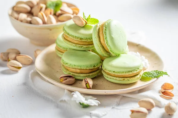 Homemade and sweet pistachio macaroons as a tasty spring snack. Green macaroons made of nuts.