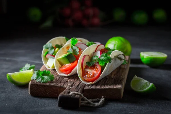 Vegetarian tacos with avocado and lime, coriander. Tacos with vegetables as a Mexican snack.
