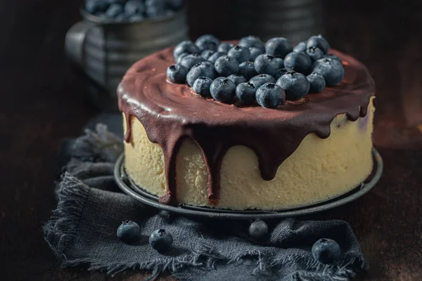 Homemade and sweet cheesecake with chocolate and fruits. Blueberry cheesecake with chocolate topping.