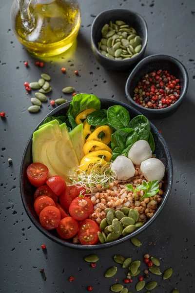 Fit salad with avocado, tomatoes, cheese and groats. Healthy bowls on a diet.