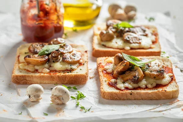 Homemade and delicious toasts made of mushrooms, pepper and cheese. Vegetarian toasts with mushrooms and cheese.