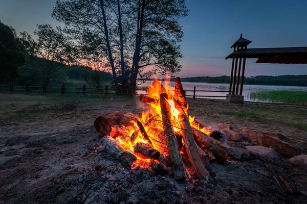 Summer bonfire by the lake in summer, Poland, Europe