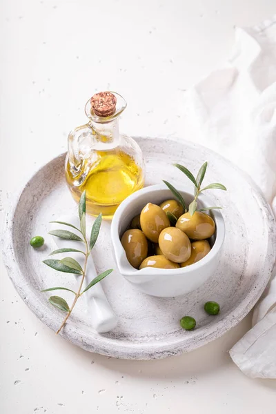 Green and tasty olives with extra virgin olive oil. Preserves made from olives.