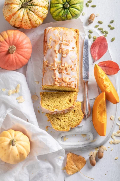 Sweet pumpkin pound cake with almonds and white glaze. Autumn pumpkin bread sliced.