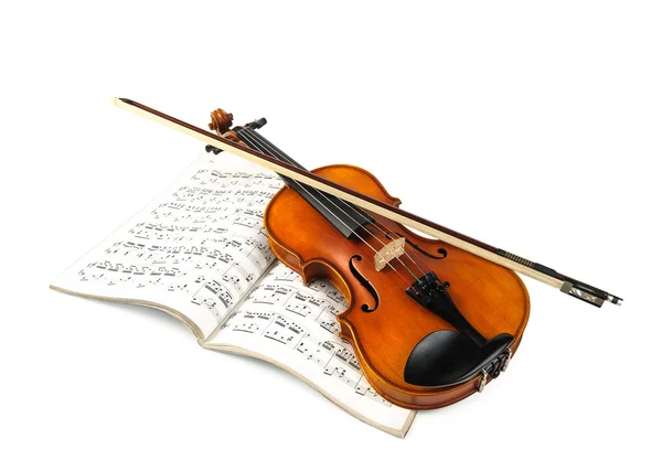 Violin and fiddle stick over score — Stock Photo, Image
