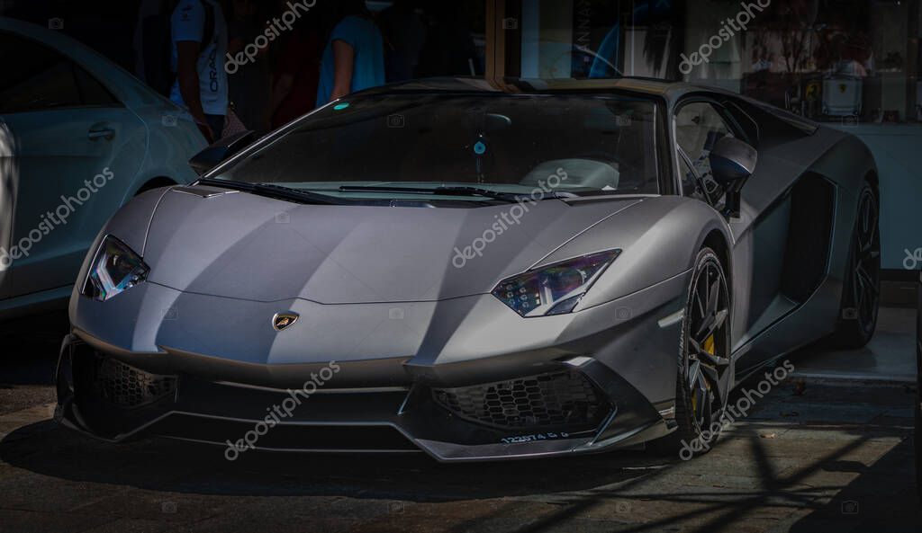 A picture of a Lamborghini Aventador parked on the street.