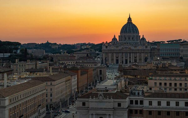 A picture of the Saint Peter's Basilica and the Via della Conciliazione at sunset.