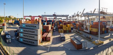 A picture of colorful cargo containers at the Leixoes Container Terminal at sunset.