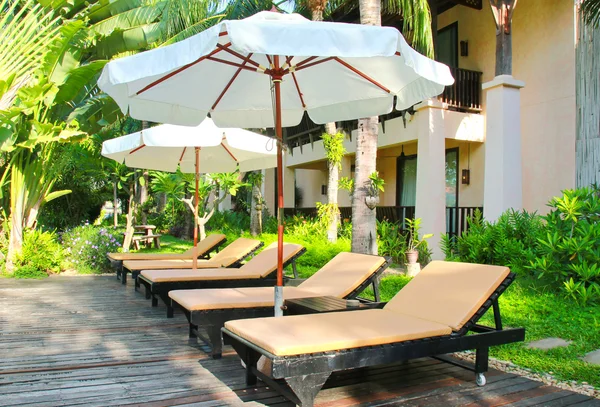 Chairs and umbrella near pool — Stock Photo, Image