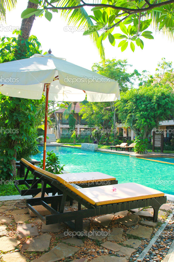 Chairs and umbrella near pool