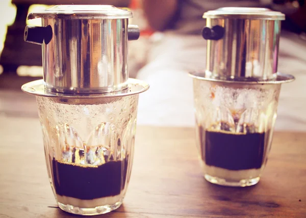 Vietnamese coffee in glass cups, traditional metal coffee maker phin. Black drip  coffee as famous in Vietnam 25499474 Stock Photo at Vecteezy