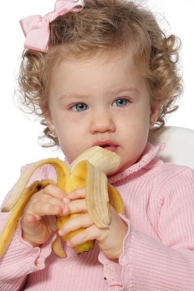 Baby girl eating fruit — Stock Photo, Image