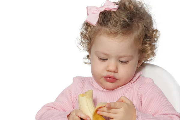 Baby girl eating fruit — Stock Photo, Image