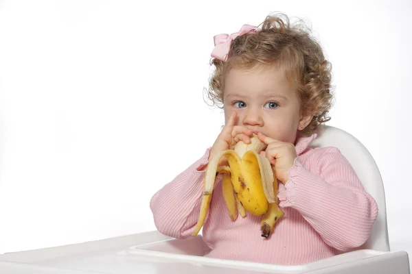 Baby girl eating fruit — Stock Photo, Image