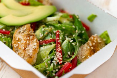 Paketinde avokado olan tavuk salatası. Sağlıklı öğle yemeği